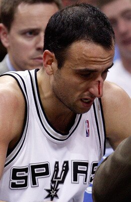 SAN ANTONIO - APRIL 23:  Guard Manu Ginobili #20 of the San Antonio Spurs is attended to after being hit in the nose against the Dallas Mavericks in Game Three of the Western Conference Quarterfinals during the 2010 NBA Playoffs at AT&T Center on April 23