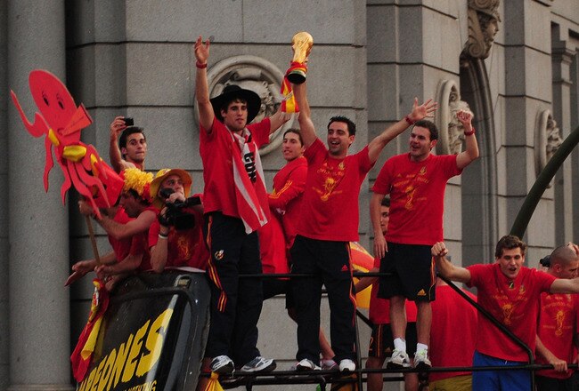 MADRID, SPAIN - JULY 12: Xavi Hernandez holds aloft the FIFA World Cup to the crowds gathered in Plaza Cibeles on July 12, 2010 in Madrid, Spain after Spain won the FIFA World Cup.  (Photo by Denis Doyle/Getty Images)