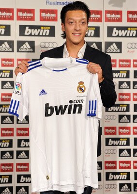 MADRID, SPAIN - AUGUST 18:  New signing Mesut Ozil poses with a Real Madrid shirt during his presentation as new Real Madrid player at the Estadio Santiago Bernabeu on August 18, 2010 in Madrid, Spain.  (Photo by Jasper Juinen/Getty Images)