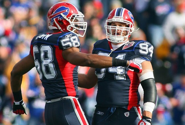 ORCHARD PARK, NY - NOVEMBER 01:  Aaron Maybin #58 and Aaron Schobel #94 of the Buffalo Bills meet on the field during the game against the Houston Texans at Ralph Wilson Stadium on November 1, 2009 in Orchard Park, New York. Houston won 31-10. (Photo by R