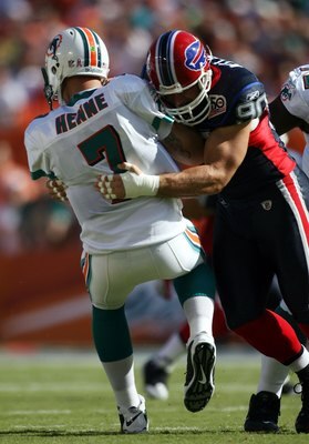 MIAMI - OCTOBER 04:  Quarterback Chad Henne #7 of the Miami Dolphins is sacked by defensive end Chris Kelsay #90 of the Buffalo Bills at Land Shark Stadium on October 4, 2009 in Miami, Florida.  Miami defeated Buffalo 31-30. (Photo by Marc Serota/Getty Im
