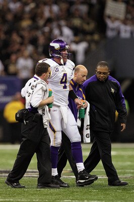 NEW ORLEANS - JANUARY 24:  Brett Favre #4 of  the Minnesota Vikings is helped off the field by medical staff after getting injured on a play against the New Orleans Saints during the NFC Championship Game at the Louisiana Superdome on January 24, 2010 in 