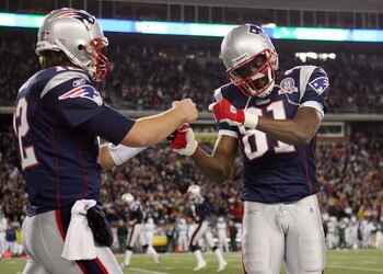 FOXBORO, MA - NOVEMBER 22:  Randy Moss #81 and Tom Brady #12 of the New England Patriots celebrate Laurence Maroney's touchdown in the second quarter against the New York Jets on November 22, 2009 at Gillette Stadium in Foxboro, Massachusetts.  (Photo by 