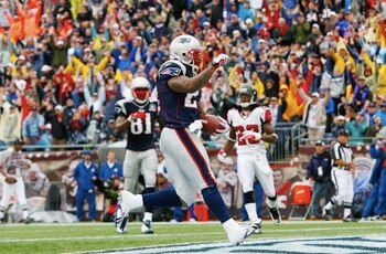 FOXBORO, MA - SEPTEMBER 27:  Running back Fred Taylor #21 of the New England Patriots rushes in for an 8-yard touchdown against the Atlanta Falcons during the second quarter of the game at Gillette Stadium on September 27, 2009 in Foxboro, Massachusetts.