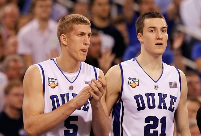 INDIANAPOLIS - APRIL 05:  Mason Plumlee #5 and Miles Plumlee #21 of the Duke Blue Devils support their teamates from the bench against the Butler Bulldogs during the 2010 NCAA Division I Men's Basketball National Championship game at Lucas Oil Stadium on
