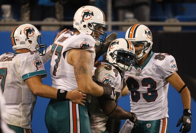 CHARLOTTE - NOVEMBER 19: (L-R) Chad Henne #7 Jake Long #77, Ricky Williams #34 and Greg Camarillo #83 of the Miami Dolphins celebrate after Williams scored a 46 yard rushing touchdown against the Carolina Panthers at Bank of America Stadium on November 19