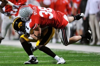 COLUMBUS, OH - NOVEMBER 14:  Linebacker Austin Spitler #38 of the Ohio State Buckeyes tackles wide receiver Marvin McNutt #7 of the Iowa Hawkeyes at Ohio Stadium on November 14, 2009 in Columbus, Ohio.  (Photo by Jamie Sabau/Getty Images)