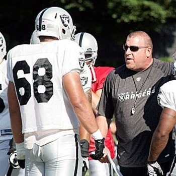 Jared Veldheer receives instructions from head coach Tom Cable.
