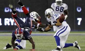 Donald Jones fumbles ball after getting upended.