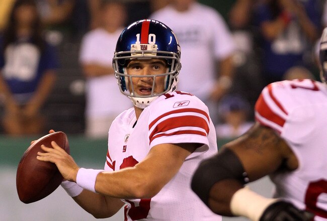 EAST RUTHERFORD, NJ - AUGUST 16:  Eli Manning #10 of the New York Giants drops back to pass in the first quarter during their game against the New York Jets at New Meadowlands Stadium on August 16, 2010 in East Rutherford, New Jersey.  (Photo by Nick Laha