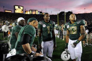 PASADENA, CA - JANUARY 01:  (L-R) Running back LeGarrette Blount #8, quarterback Jeremiah Masoli #9, quarterback Darron Thomas #1, and defensive end Tyrell Irvin #33 of the Oregon Ducks react to a touchdown by the Ohio State Buckeyes during the 96th Rose