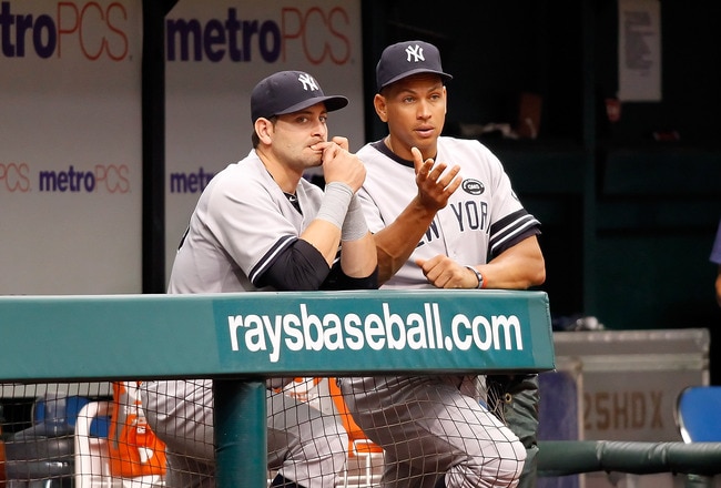 ST. PETERSBURG - AUGUST 01:  Infielder Alex Rodriguez #13 of the New York Yankees talks with catcher Francisco Cervelli #29 at the end of the dugout during the game against the Tampa Bay Rays at Tropicana Field on August 1, 2010 in St. Petersburg, Florida