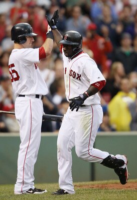 BOSTON - AUGUST 22:  Bill Hall #22 of the Boston Red Sox is congratulated by teammate Ryan Kalish #55 after Hall hit a two run homer in the fifth inning against the Toronto Blue Jays on August 22, 2010 at Fenway Park in Boston, Massachusetts.  (Photo by E