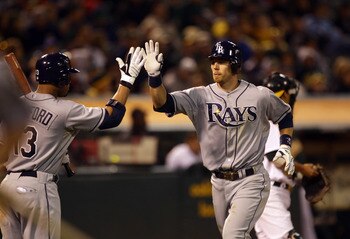 OAKLAND, CA - AUGUST 20:  Ben Zobrist #18 of the Tampa Bay Rays is congratulated by Carl Crawford #13 after he hit a home run to give the Rays a 4-3 lead in the seventh inning of their game against the Oakland Athletics at the Oakland-Alameda County Colis