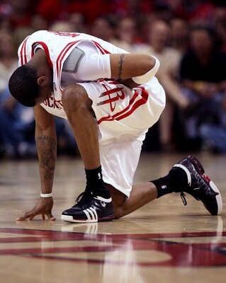 HOUSTON - APRIL 19:  Tracy McGrady #1 of the Houston Rockets kneels and holds his stomach after being fouled against the Utah Jazz in Game One of the Western Conference Quarterfinals during the 2008 NBA Playoffs at the Toyota Center on April 19, 2008 in H