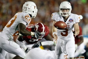 PASADENA, CA - JANUARY 07:  Quarterback Garrett Gilbert #3 of the Texas Longhorns pitches the ball back to Tre' Newton #23 against the Alabama Crimson Tide during the Citi BCS National Championship game at the Rose Bowl on January 7, 2010 in Pasadena, Cal