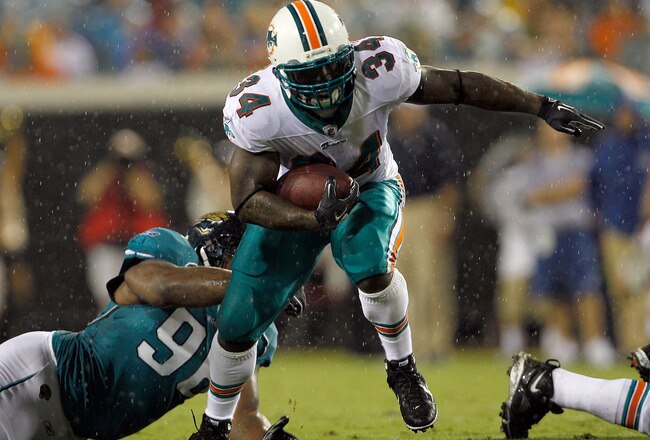 JACKSONVILLE, FL - AUGUST 21:  Terrance Knighton #96 of the Jacksonville Jaguars attempts to tackle Ricky Williams #34 of the Miami Dolphins during the preseason game at EverBank Field on August 21, 2010 in Jacksonville, Florida.  (Photo by Sam Greenwood/