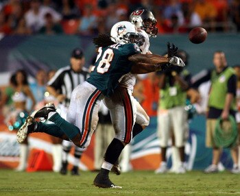 MIAMI - AUGUST 14: Cornerback Nolan Carroll #28  of the Miami Dolphins (L) breaks up a pass intended to Tight End Ryan Pervis #46 of the Tampa Bay Buccaneers during the preseason game at Sun Life Stadium on August 14, 2010 in Miami, Florida.  (Photo by Ma