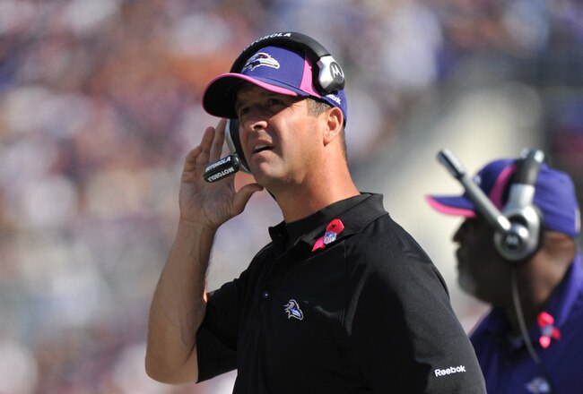 BALTIMORE, MD - OCTOBER 10: Head coach John Harbaugh of the Baltimore Ravens coaches against the Denver Broncos at M&T Bank Stadium on October 10, 2010 in Baltimore, Maryland. Players wore pink in recognition of Breast Cancer Awareness Month. The Ravens d