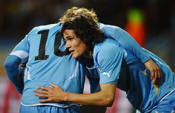 PORT ELIZABETH, SOUTH AFRICA - JULY 10:  Edinson Cavani of Uruguay (R) celebrates with Diego Forlan as he scores their first goal during the 2010 FIFA World Cup South Africa Third Place Play-off match between Uruguay and Germany at The Nelson Mandela Bay 