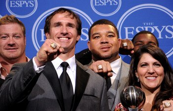 LOS ANGELES, CA - JULY 14:  Jeremy Shockey, Drew Brees, Jonathan Goodwin and Rita Benson Leblanc  pose along with members of the New Orleans Saints after winning the ESPY for Best Team during the 2010 ESPY Awards at Nokia Theatre L.A. Live on July 14, 201