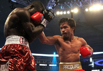 ARLINGTON, TX - MARCH 13:  (R-L) Manny Pacquiao of the Philippines throws a right to the head of Joshua Clottey of Ghana during the WBO welterweight title fight at Cowboys Stadium on March 13, 2010 in Arlington, Texas.  (Photo by Jed Jacobsohn/Getty Image