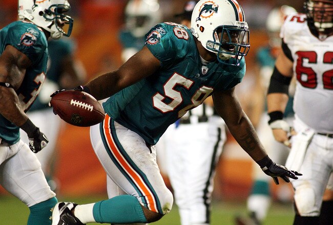 MIAMI - AUGUST 27: Linebacker Karlos Dansby #58 of the Miami Dolphins celebrates his fumble recovery against the Atlanta Falcons during preseason action at Sun Life Stadium on August 27, 2010 in Miami, Florida.  (Photo by Marc Serota/Getty Images)