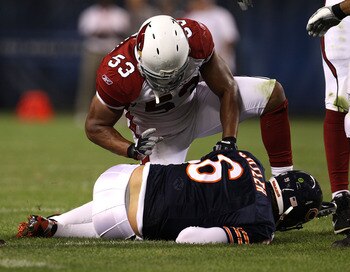 CHICAGO - AUGUST 28: Clark Haggans #53 of the Arizona Cardinals kneels over Jay Cutler #6 of the Chicago Bears after a sack during a preseason game at Soldier Field on August 28, 2010 in Chicago, Illinois. The Cardinals defeated the Bears 14-9. (Photo by 