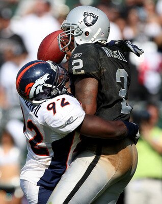 OAKLAND, CA - SEPTEMBER 27:  JaMarcus Russell #2 of the Oakland Raiders is sacked by Elvis Dumervil #92 of the Denver Broncos on September 27, 2009 during an NFL game at the Oakland-Alameda County Coliseum in Oakland, California.  (Photo by Jed Jacobsohn/