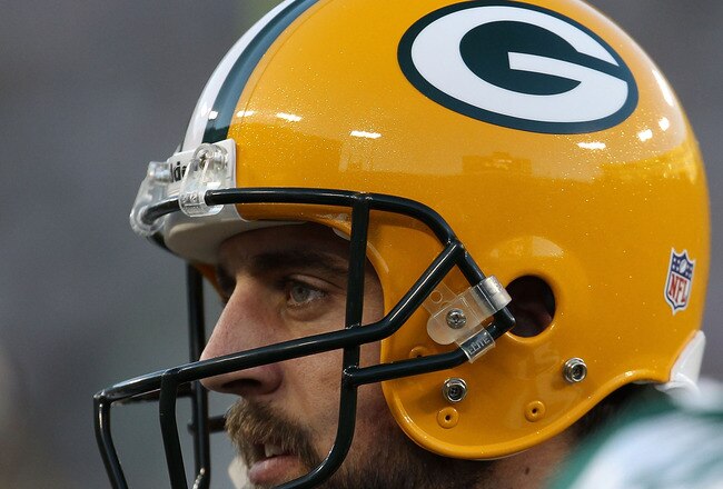 GREEN BAY, WI - AUGUST 26: Aaron Rodgers #12 of the Green Bay Packers talks with teammates before entering the field against the Indianapolis Colts during a preseason game at Lambeau Field on August 26, 2010 in Green Bay, Wisconsin. The Packers defeated t