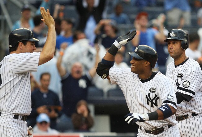 NEW YORK - AUGUST 22: (L - R) Mark Teixeira #25 of the New York Yankees celebrates with Robinson Cano #24  after Cano's grand slam home run against the Seattle Mariners in the fifth inning on August 22, 2010 at Yankee Stadium in the Bronx borough of New Y