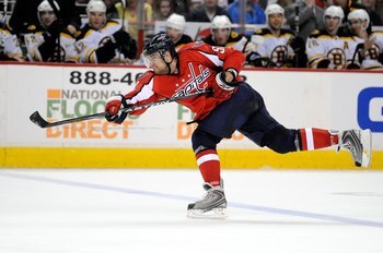WASHINGTON - APRIL 11:  Mike Green #52 of the Washington Capitals shoots the puck against the Boston Bruins at the Verizon Center on April 11, 2010 in Washington, DC.  (Photo by Greg Fiume/Getty Images)