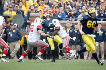 ANN ARBOR, MI - NOVEMBER 21:  Quarterback Tate Forcier #5 of the Michigan Wolverines is sacked by Brian Rolle #36 the Ohio State Buckeyes on November 21, 2009 at Michigan Stadium in Ann Arbor, Michigan. Ohio State won the game 21-10. (Photo by Gregory Sha