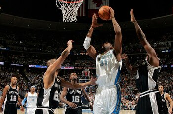 DENVER - APRIL 30:  Nene #31 of the Denver Nuggets goes up against Tim Duncan #21, Michael Finley #4, and Francisco Elson #16 of the San Antonio Spurs in the first quarter of Game Four of the Western Conference Quarterfinals during the 2007 NBA Playoffs a