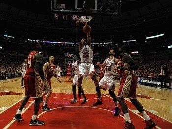 CHICAGO - APRIL 25: Taj Gibson #22 of the Chicago Bulls dunks the ball over teammates Luol Deng #9 and Brad Miller #52 as well as LeBron James #23, Anthony Parker #18 and J.J. Hickson #21 of the Cleveland Cavaliers in Game Four of the Eastern Conference Q