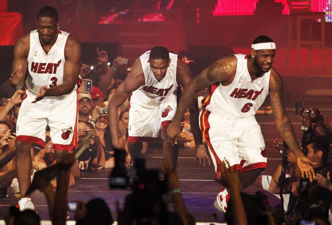 MIAMI - JULY 09:  Fans cheer as (L-R) Dwyane Wade #3, Chris Bosh #1 and LeBron James #6 of the Miami Heat are introduced during a welcome party at American Airlines Arena on July 9, 2010 in Miami, Florida.  (Photo by Marc Serota/Getty Images)