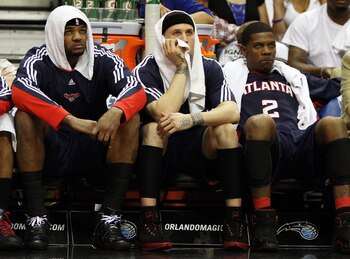 ORLANDO, FL - MAY 04:  (L to R) Josh Smith #5, Mike Bibby #10 and Joe Johnson #2 of the Atlanta Hawks sit on the bench and watch the fourth quarter against the Orlando Magic in Game One of the Eastern Conference Semifinals during the 2010 NBA Playoffs at