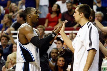 ORLANDO, FL - MAY 26:  Dwight Howard #12 of the Orlando Magic greets Ryan Anderson as he returns to the bench against the Boston Celtics in Game Five of the Eastern Conference Finals during the 2010 NBA Playoffs at Amway Arena on May 26, 2010 in Orlando,