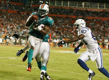 MIAMI - SEPTEMBER 21:  Wide receiver Reggie Wayne #87 of the Indianapolis Colts watches as safety Gibril Wilson #28 of the Miami Dolphins tries to grab an interception at Land Shark Stadium on September 21, 2009 in Miami, Florida. After being called an in