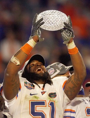 MIAMI - JANUARY 08:  Brandon Spikes #51 of the Florida Gators holds up the winning trophy after the FedEx BCS National Championship Game against the Oklahoma Sooners at Dolphin Stadium on January 8, 2009 in Miami, Florida.  (Photo by Eliot J. Schechter/Ge