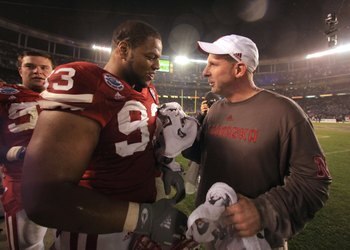 SAN DIEGO - DECEMBER 30:  Ndamukong Suh #93 talks with Head Coach Bo Pelini of the University of Nebraska Cornhuskers after their team's 33-0 victory against the University of Arizona Wildcats during the Pacific Life Holiday Bowl, on December 30, 2009 at 