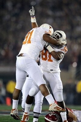 PASADENA, CA - JANUARY 07:  Defensive end Sam Acho #81 and Kheeston Randall #91 of the Texas Longhorns celebrate a sack of quarterback Greg McElroy #12 of the Alabama Crimson Tide in the first quarter of the Citi BCS National Championship game at the Rose