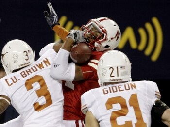 ARLINGTON, TX - DECEMBER 5:  Wide receiver Brandon Kinnie #84 of the Nebraska Cornhuskers cannot hold on for an incomplete pass in front of Curtis Brown #3 and Blake Gideon #21 of the Texas Longhorns in the first quarter of the game at Cowboys Stadium on