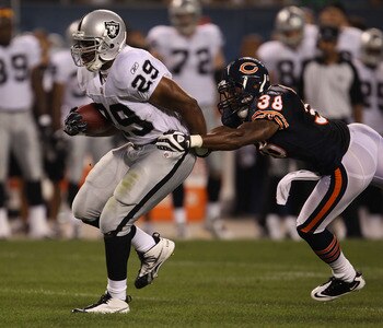 CHICAGO - AUGUST 21: Michael Bush #29 of the Oakland Raiders breaks away from Danieal Manning #38 of the Chicago Bears during a preseason game at Soldier Field on August 21, 2010 in Chicago, Illinois. The Raiders defeated the Bears 32-17. (Photo by Jonath