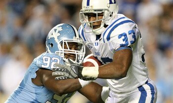 CHAPEL HILL, NC - NOVEMBER 07:  Desmond Scott #33 of the Duke Blue Devils is tackled by E.J. Wilson #92 of the North Carolina Tar Heels during their game at Kenan Stadium on November 7, 2009 in Chapel Hill, North Carolina.  (Photo by Streeter Lecka/Getty