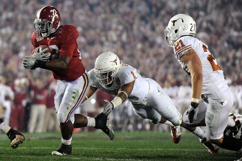PASADENA, CA - JANUARY 07:  Running back Mark Ingram #22 of the Alabama Crimson Tide runs with the ball as Keenan Robinson #1 of the Texas Longhorns tries to tackle during the Citi BCS National Championship game at the Rose Bowl on January 7, 2010 in Pasa