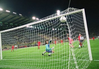 26 Jun 1990:  John Barnes of England (L) shoots past Michel Preud'homme of Belgium, but the goal is ruled out for offside during the FIFA World Cup Finals 1990 second round match against Belgium played at the Dall''Ara Stadium, in Bologna, Italy. England