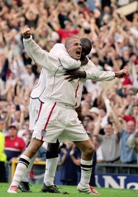 6 Oct 2001:  David Beckham of England celebrates with Emile Heskey after scoring an injury time equalising goal during the World Cup Group 9 Qualifier between England and Greece at Old Trafford in Manchester, England. England sealed qualification after th