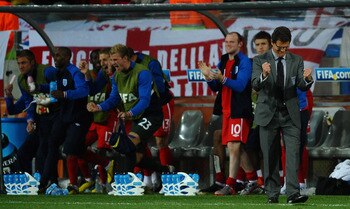 PORT ELIZABETH, SOUTH AFRICA - JUNE 23:  Fabio Capello manager of England celebrates victory in front of his subs bench during the 2010 FIFA World Cup South Africa Group C match between Slovenia and England at the Nelson Mandela Bay Stadium on June 23, 20