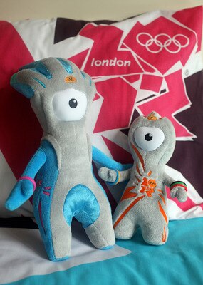 LONDON, ENGLAND - JULY 30:  Wenlock (R) and Mandeville (L), soft toy mascots for the London 2012 Olympic Games, are placed on a London 2012 bedspread at the launch of the London Olympic Games official merchandise on July 30, 2010 in London, England. The m